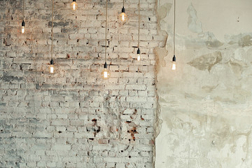 The retro light bulbs against the white brick wall. loft interior