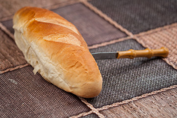 Homemade bread and knife on the kitchen table.Tasty food