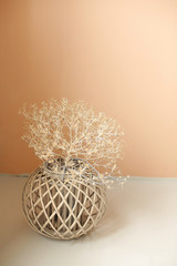 Vintage vase with dry flowers against of a beige wall background. Minimalism interior. Copy space
