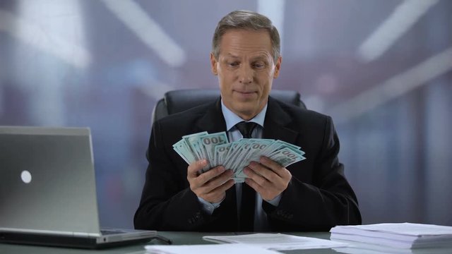 Happy company head counting dollars, rejoicing work result, financial increase