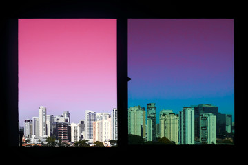 The view of the Skyscraper buildings through the window with a pink neon sky. City Concept