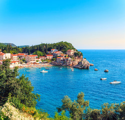 Picturesque summer view of Adriatic sea coast in Budva Riviera. Przno village with buildings on the...