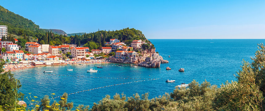 Picturesque summer view of Adriatic sea coast in Budva Riviera. Przno village with buildings on the rock, Montenegro