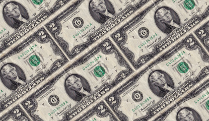 Old rumpled two dollar notes are decomposed diagonally