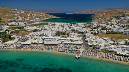 Aerial drone photo of paradise celebrity bay of Ornos famous for pool resorts and sandy turquoise organised clear sea beach, Mykonos island, Cyclades, Greece