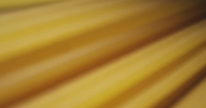 Closeup motion shoot of italian pasta spaghetti type being thrown from the side with background isolated on black
