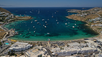 Aerial drone photo of paradise celebrity bay of Ornos famous for pool resorts and sandy turquoise organised clear sea beach, Mykonos island, Cyclades, Greece