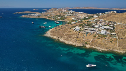 Aerial drone photo of paradise celebrity bay of Ornos famous for pool resorts and sandy turquoise organised clear sea beach, Mykonos island, Cyclades, Greece