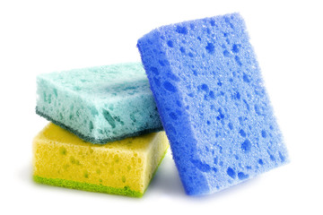 Colored sponges for washing dishes and other domestic needs. Yellow, mint and blue sponges are located next to each other. isolate