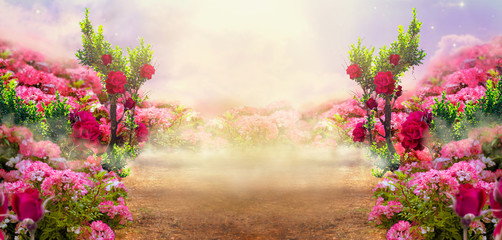 Fantasy summer panoramic photo background with rose field, trees and misty path leading to mysterious glade. Idyllic tranquil morning scene and empty copy space. Road goes across hills to fairytale.