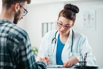 Woman Doctor prescribes medicine to Young Patient