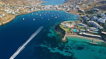 Fototapeta na wymiar Aerial drone photo of paradise celebrity bay of Ornos famous for pool resorts and sandy turquoise organised clear sea beach, Mykonos island, Cyclades, Greece