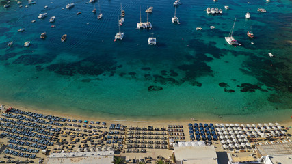 Aerial drone photo of paradise celebrity bay of Ornos famous for pool resorts and sandy turquoise organised clear sea beach, Mykonos island, Cyclades, Greece