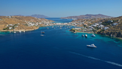Fototapeta na wymiar Aerial drone photo of luxury yachts docked in famous turquoise clear sea bay of Ornos, Mykonos island, Cyclades, Greece