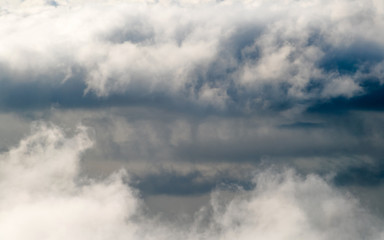 Dark stormy rain clouds in the sky. Dramatic rain cloud background without land, bad weather