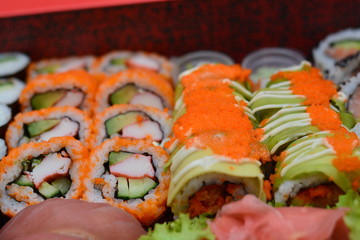 sushi on a plate avocado and orange egg on it