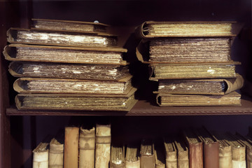 Ancient medieval books on the shelf in the bookcase.