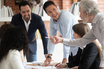 Happy diverse business team talking gather at conference table