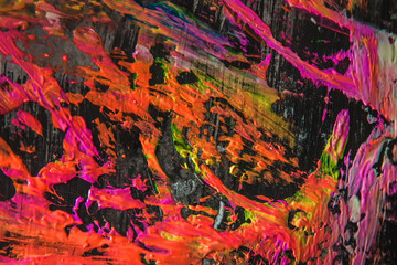 Splashes and smears of colored paint paints on black background