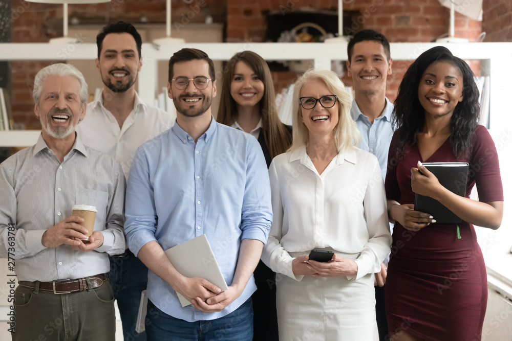 Sticker Happy diverse business team standing in office looking at camera