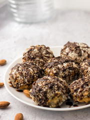 Useful homemade almond cake with coconut chips on a light background, copy space