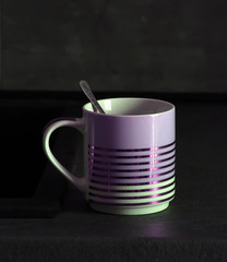 ceramic cup on a dark background in the interior of the kitchen
