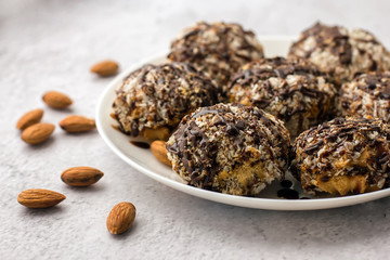 Useful homemade almond cake with coconut chips on a light background, copy space