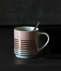 ceramic cup on a dark background in the interior of the kitchen
