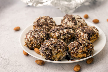 Useful homemade almond cake with coconut chips on a light background, copy space