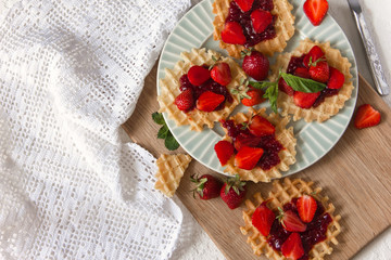 Viennese waffles with strawberries on a gray background. food photography . Flat gasket. Flatley