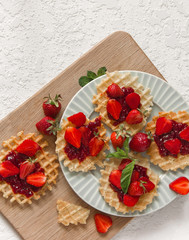 Viennese waffles with strawberries on a gray background. food photography . Flat gasket. Flatley