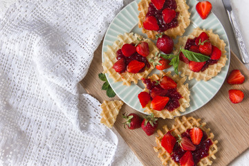 Viennese waffles with strawberries on a gray background. food photography . Flat gasket. Flatley