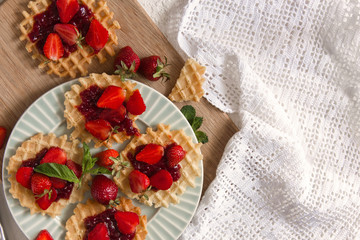 Viennese waffles with strawberries on a gray background. food photography . Flat gasket. Flatley