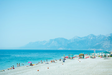Konyaaalti beach in Antalya, Turkey, blue mediterranean sea, sunny weather. Travel and vacation at the resort