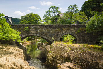 Fototapeta na wymiar The medieval Pont-y-Pair Bridge over the River Llugwy in the village of Betws-y-Coed North Wales