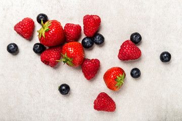 Fresh summer berries such as blueberries, strawberries, raspberries, top view
