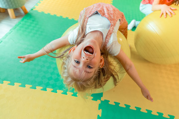 Top view of a happy excited cute girl