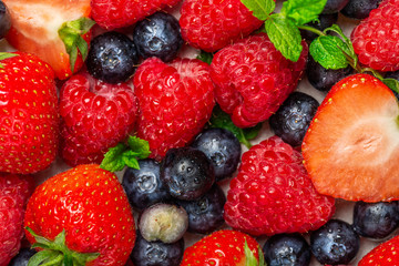 Fototapeta na wymiar Fresh summer berries such as blueberries, strawberries, raspberries, top view