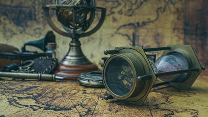 Obraz na płótnie Canvas Vintage Hourglass With Compass On Old World Map