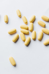 Pile of pills with medication on white background	