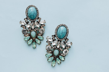 Pairs of earrings with turquoise on blue background 