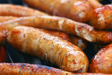grilled delicious hot sausages on the grill
