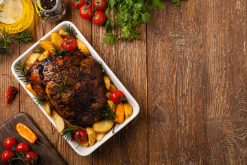 Roasted whole shoulder, with potatoes, peppers and tomatoes. Marinated in white wine.