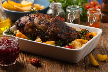 Roasted whole shoulder, with potatoes, peppers and tomatoes. Marinated in white wine.