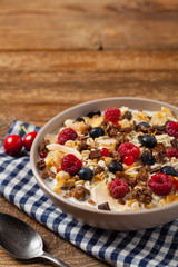 Breakfast, muesli with milk and fresh fruit.