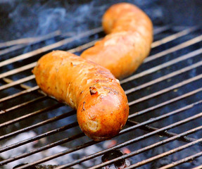 grilled appetizing sausage grilled on a fire for beer