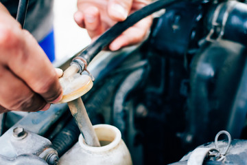 Mechanic maintenance small business service Man checking the radiator car.