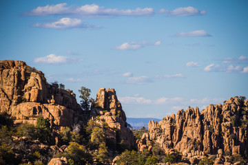 Fototapeta na wymiar The rugged Granite Dells geologic feature in Prescott Arizona. This image provides copy space in the sky with some clouds.
