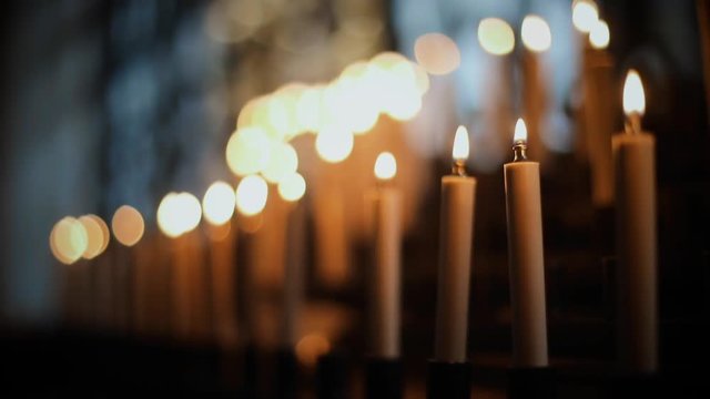 Close up HD footage of burning candles inside a church