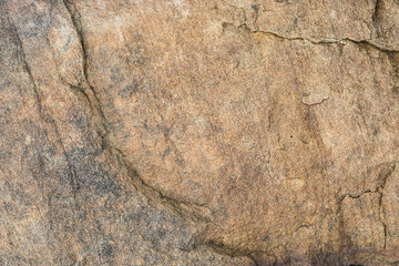 The surface of the river rocks with cracks